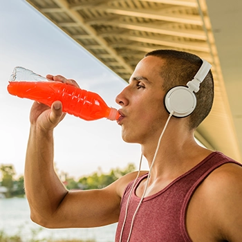 Man listening to music while drinking energy drink