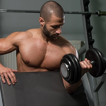 Doing seated dumbbell curls