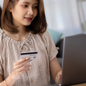 Woman holding her credit card planning to buy online