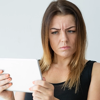 Skeptical person looking at an online shop through her device