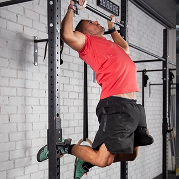 Doing kipping pull ups on a bar