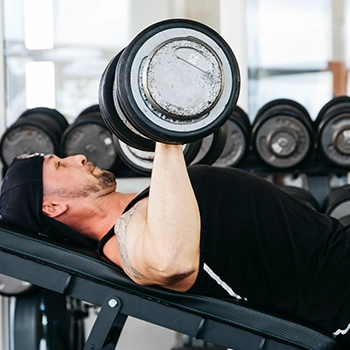 Performing dumbbell press using a big dumbbell