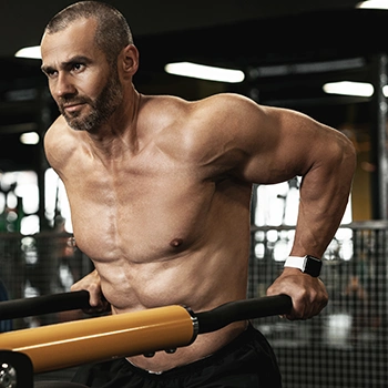 Topless person doing chest dips