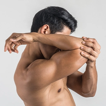 Man holding his elbow showing his arm muscles