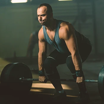 A person doing deadlifts in a gym
