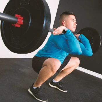 A person doing Barbell Front Squats in a gym