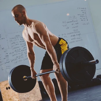 A man doing a Barbell Romanian Deadlift