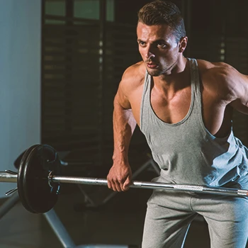 A person doing dumbell rows in the gym