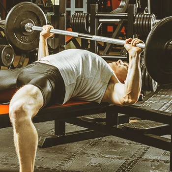 A person doing bench presses in the gym