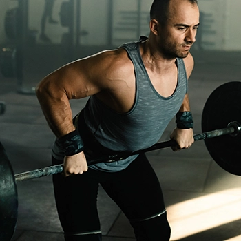 Holding a barbell doing bent over rows