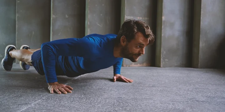 A person doing push up calisthenics for biceps