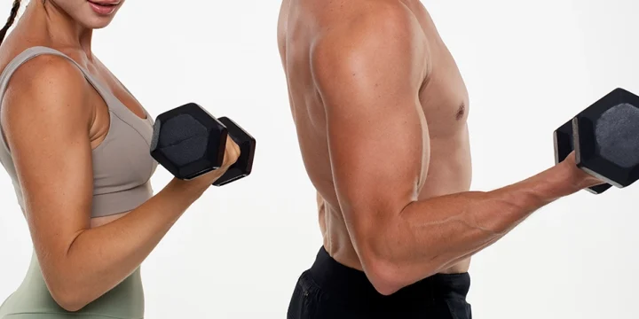 Couple doing bicep exercises using dumbbell