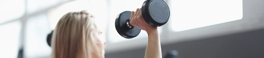 A woman performing dumbbell exercises