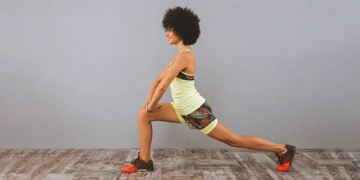 A woman doing leg isolation workouts at home