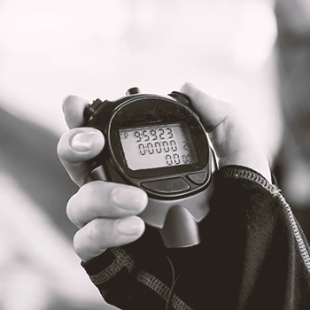 A person in the gym holding a stopwatch