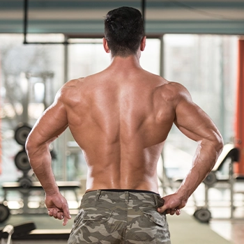 A man in the gym showing his back