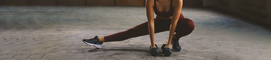 A woman doing a side lunge stretch