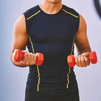 A person holding dumbbells in the gym