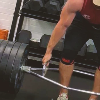 A person doing the trap bar deadlift