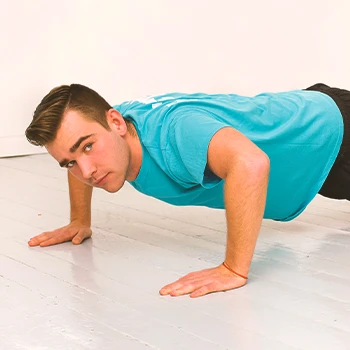 A person doing wide push ups at home