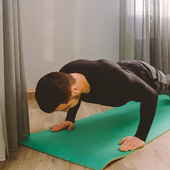 A person doing pushups indoors at home