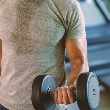 A person doing dumbbell pulls in the gym