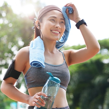 Woman wiping her sweat after workout