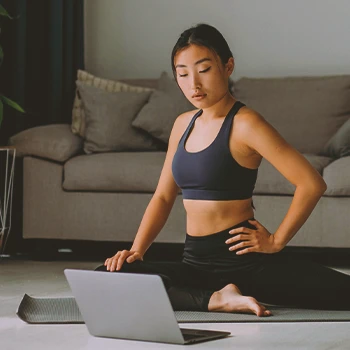 A woman looking at stretches for middle back pain online