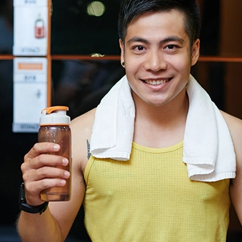 Man holding a supplement drink after workout