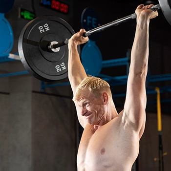 Lifting barbell doing overhead press for a full body workout