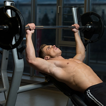 Strongman Brian Shaw's Chest Workout, lifting barbell on an inclined bench