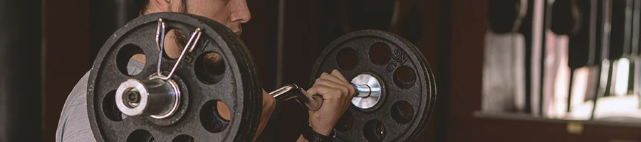 A person lifting a barbell for a 5x5 training regime