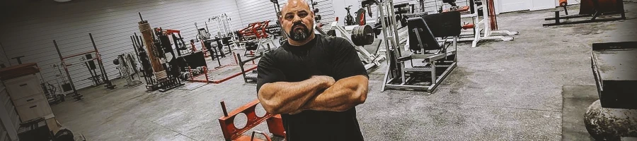 Brian Shaw posing inside a gym