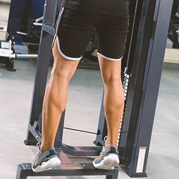 A person doing calf raises in the gym