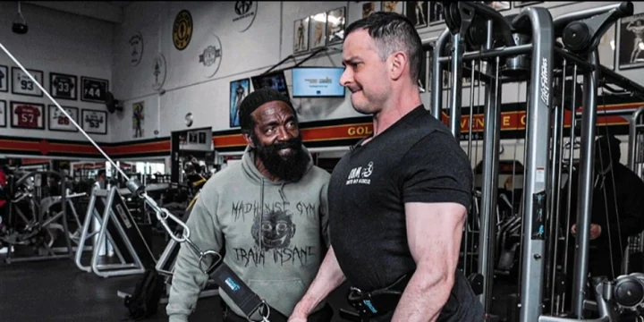 Charles Glass teaching someone about arm workouts