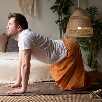 Man stretching back doing cat pose