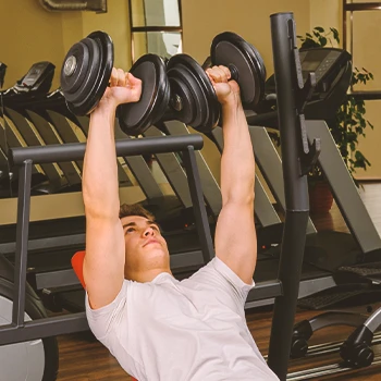 A person doing a Dumbbell Incline Bench Press