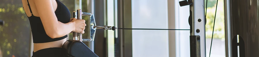 A person at a home gym using a cable machine