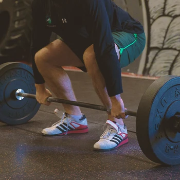 A person doing a deadlift in a gym