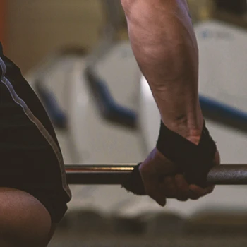 A person with lifting straps on his hands