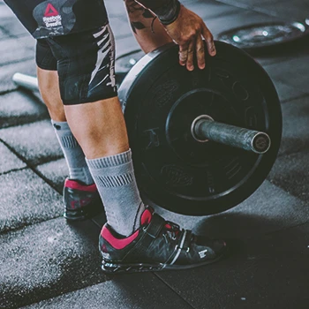 A person preparing a barbell for weight training