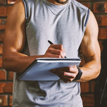 A bodybuilder calculating calories