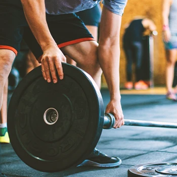 A person putting weights on a barbell