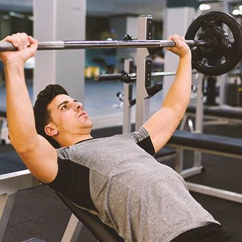 A person doing bench presses in the gym