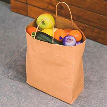 Close up shot of a grocery paper bag with food inside