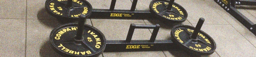Close up shot of specialty bars and barbells on the gym floor