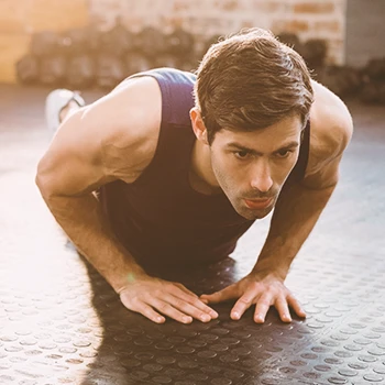 A person doing a diamond push up in the gym