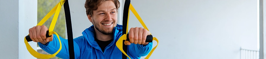 Man using suspension trainer for his workout