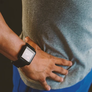 A person with a watch working out in the gym