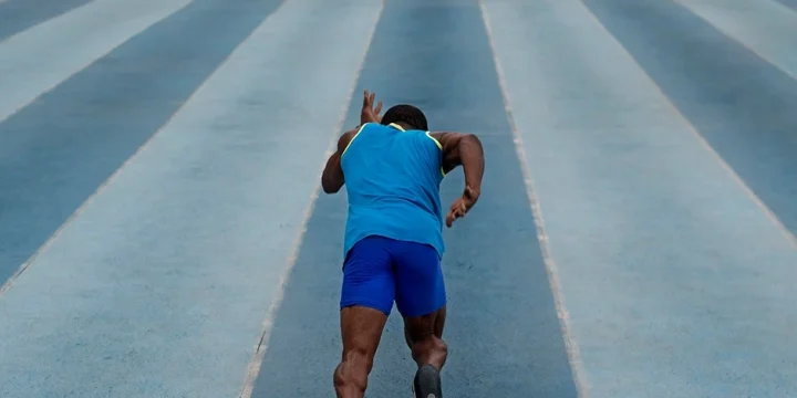 Man running on a track field
